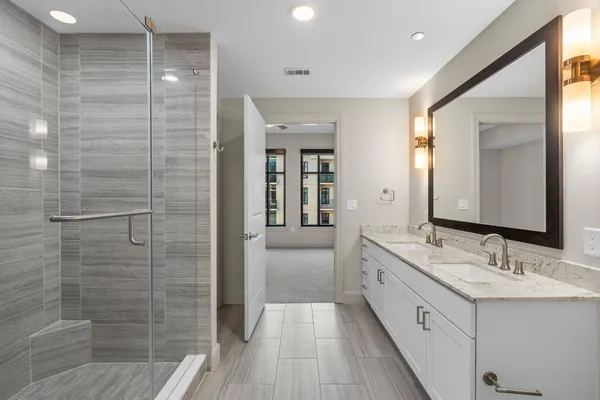 a bathroom with a shower and a mirror