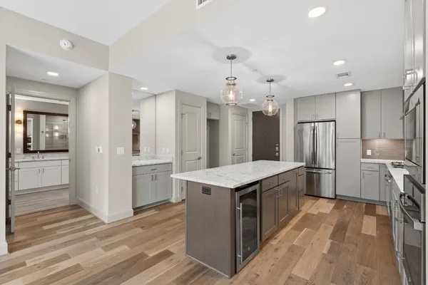 a kitchen with kitchen island a sink stainless steel appliances and cabinets
