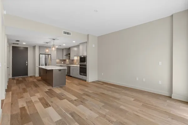 a view of a kitchen with a refrigerator and a microwave