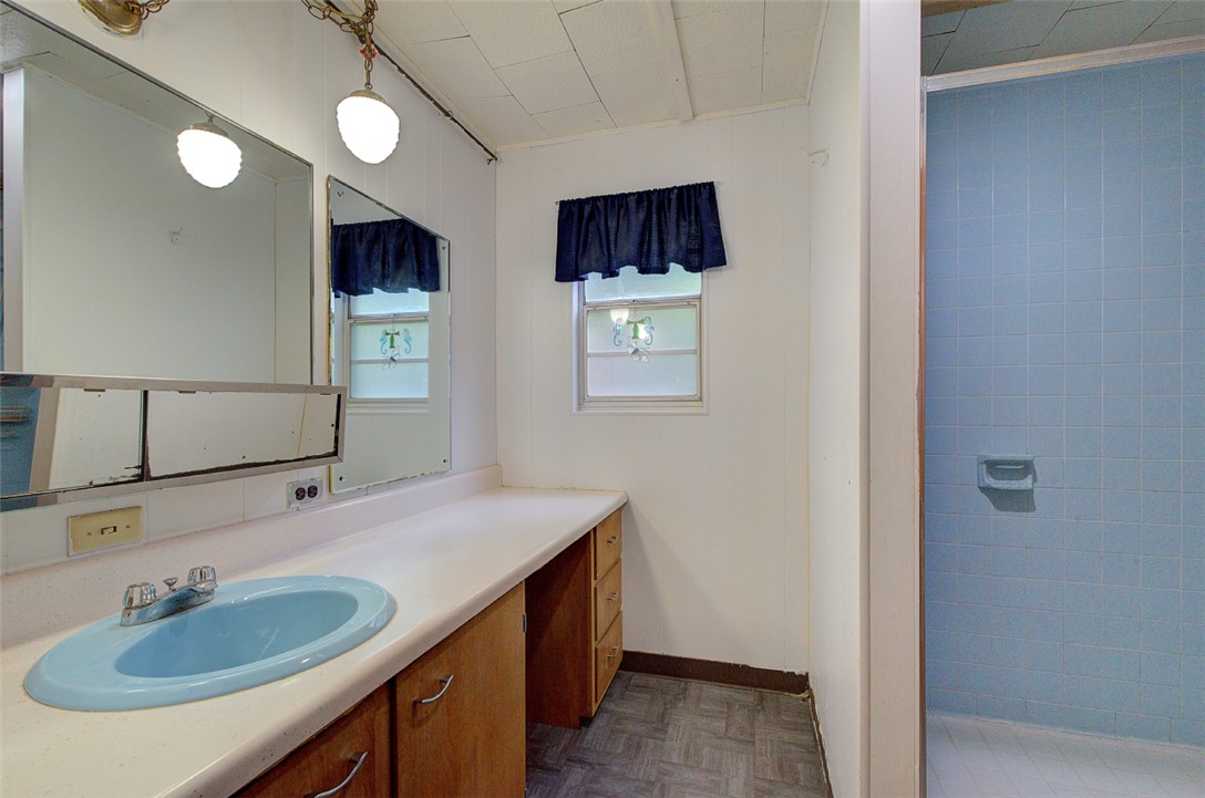 5064 Keowee School Road Seneca, SC 29672 - Photo 41 of 49 This bathroom features a functional vanity with a built-in sink and a tiled shower area.