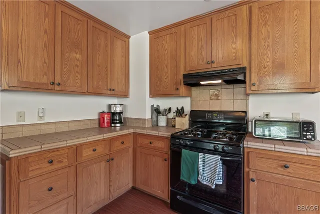 a kitchen with granite countertop cabinets and stainless steel appliances