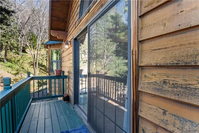 a view of a balcony with wooden floor and wooden fence