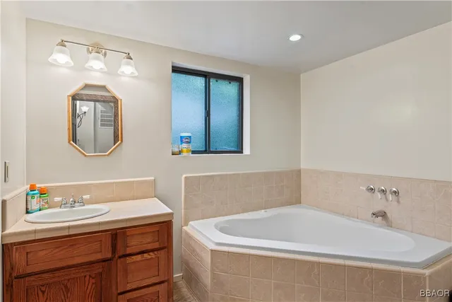 a bath tub sitting next to a bathroom sink