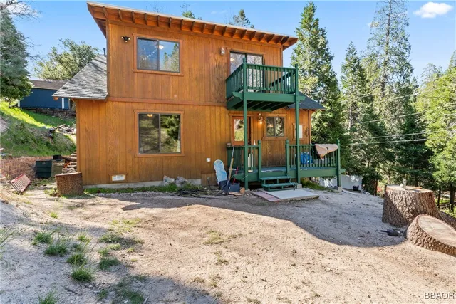 a backyard of a house with fire pit and chairs