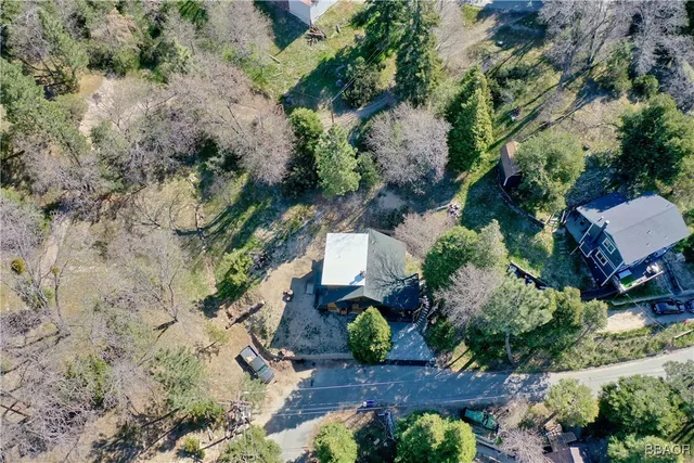 an aerial view of a house with a yard