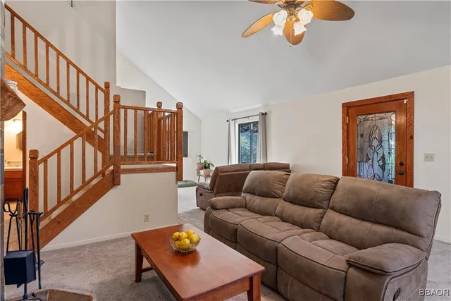 a living room with furniture a dining table and a chandelier