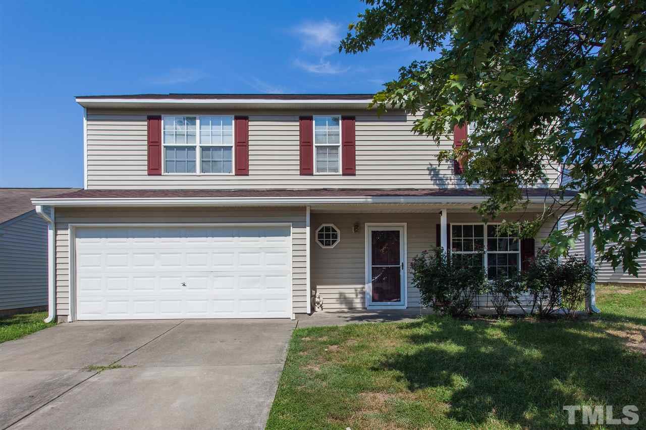 3628 Watkins Ridge Court Raleigh, NC 27616 - Photo 1 of 6 a front view of a house with a garden and plants