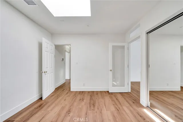 a view of an empty room and wooden floor