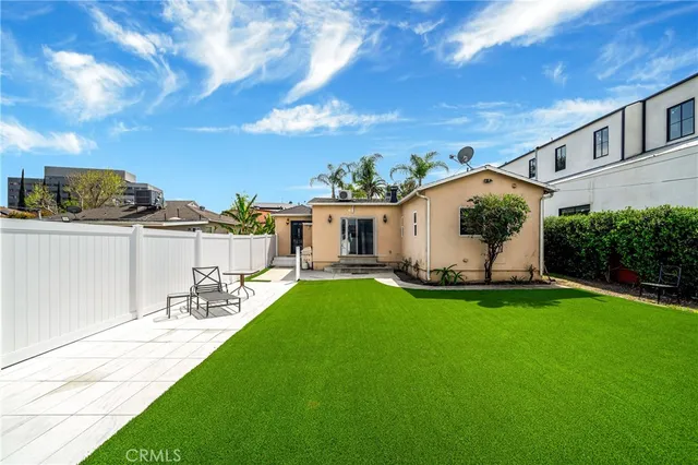 a view of a backyard with plants and a patio