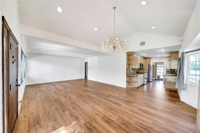 a view of a livingroom with a furniture wooden floor chandelier