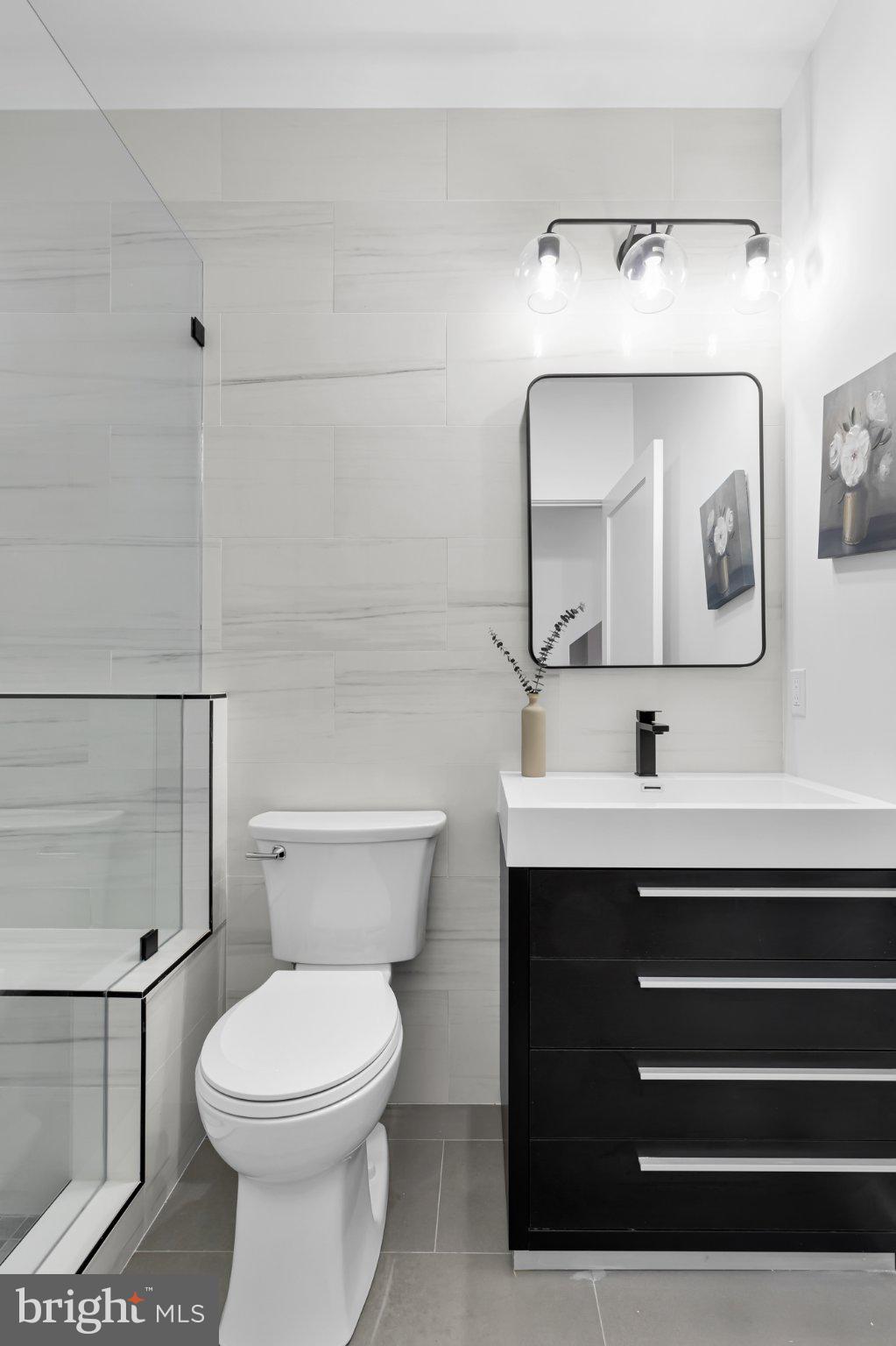 623 South Rose Street Baltimore, MD 21224 - Photo 11 of 12 a bathroom with a toilet sink and mirror