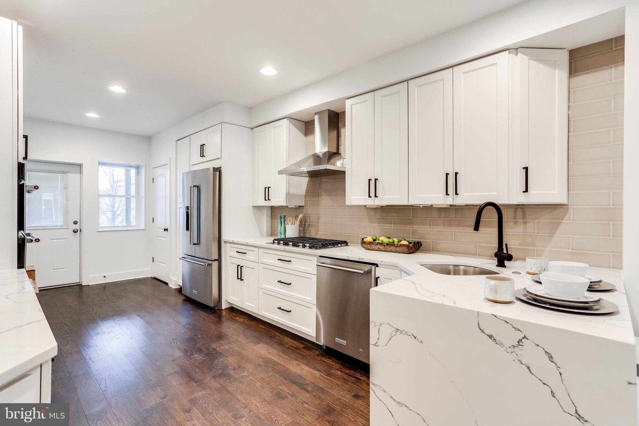 623 South Rose Street Baltimore, MD 21224 - Photo 4 of 12 a kitchen with stainless steel appliances granite countertop a stove refrigerator sink and cabinets