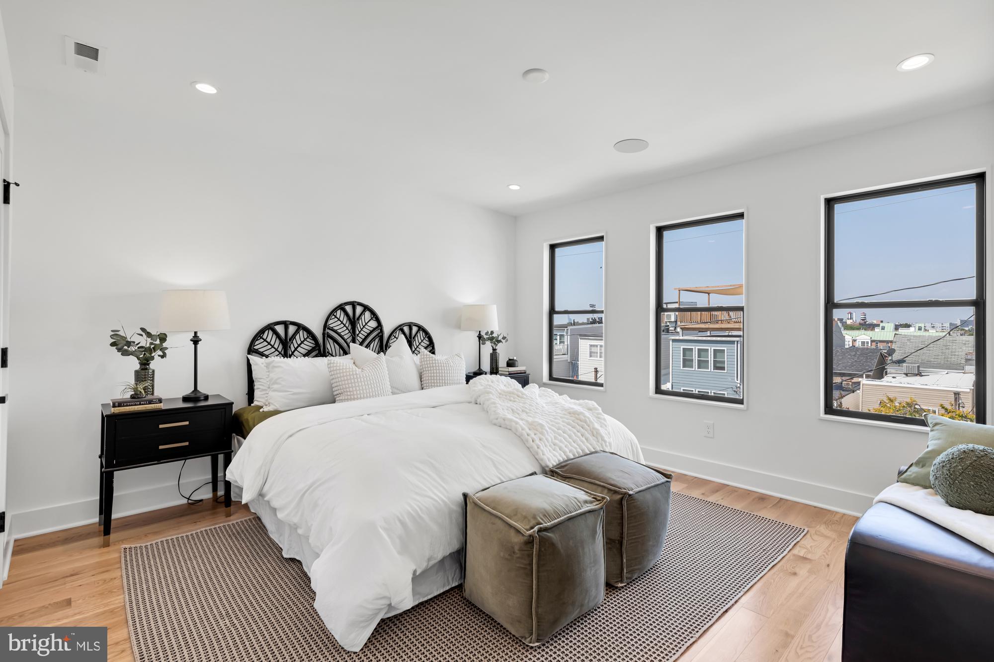 623 South Rose Street Baltimore, MD 21224 - Photo 5 of 12 a spacious bedroom with a bed and wooden floor