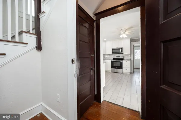 a kitchen with granite countertop a sink cabinets stainless steel appliances and a counter space