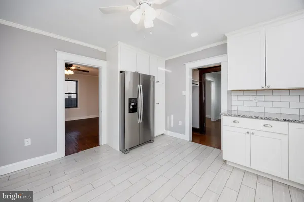 a view of an empty room with a window and closet