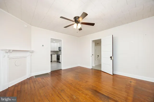 a spacious bathroom with a granite countertop sink mirror and a bathtub