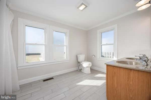a utility room with fridge dryer and washer