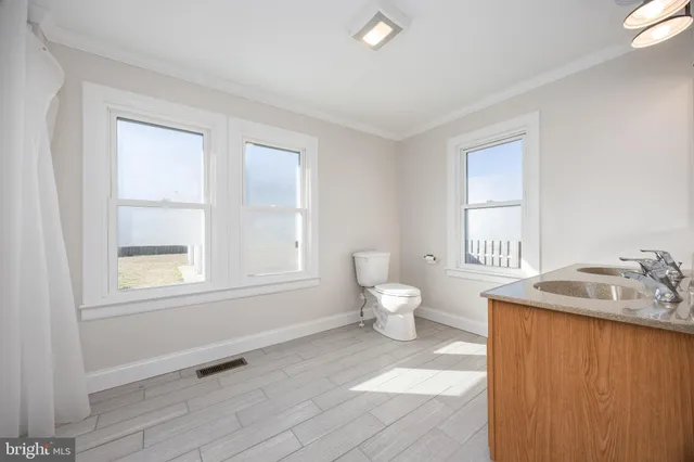 a utility room with fridge dryer and washer