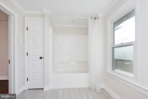 a bathroom with a granite countertop sink toilet and mirror