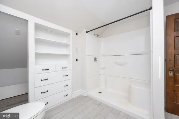 a view of a livingroom with a ceiling fan and wooden floor