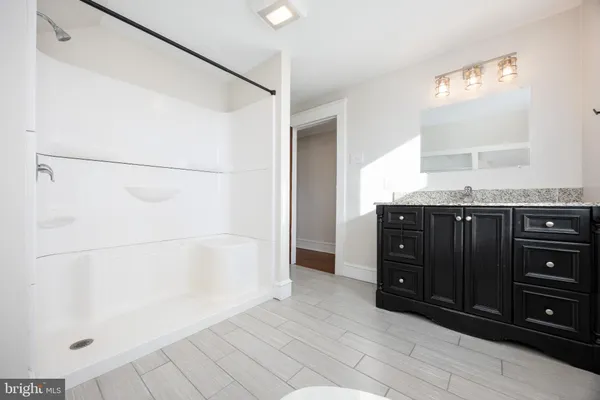 a view of empty room with wooden floor