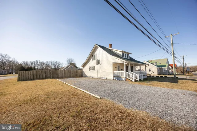 a view of staircase with wooden floor and white walls