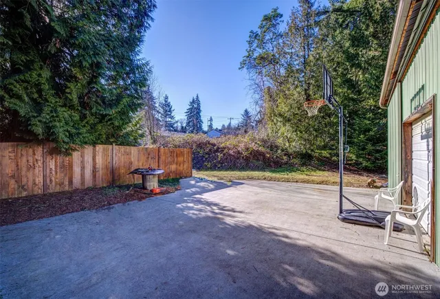 a view of a backyard with wooden fence