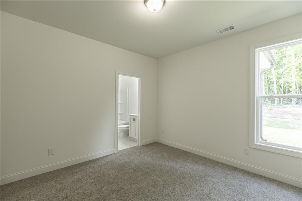 1210 Austin Road Winder, GA 30680 - Photo 29 of 56 an empty room with windows