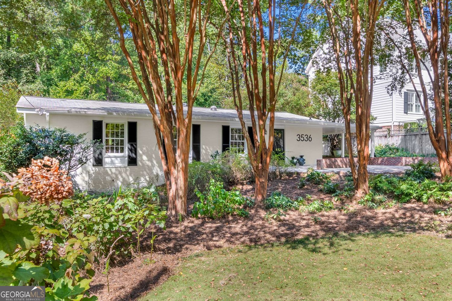 front view of a house with a garden