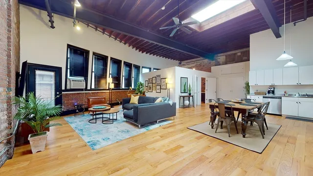 a dining room with wooden floor a table and chairs