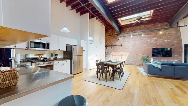 a kitchen with stainless steel appliances granite countertop sink stove top oven and cabinets