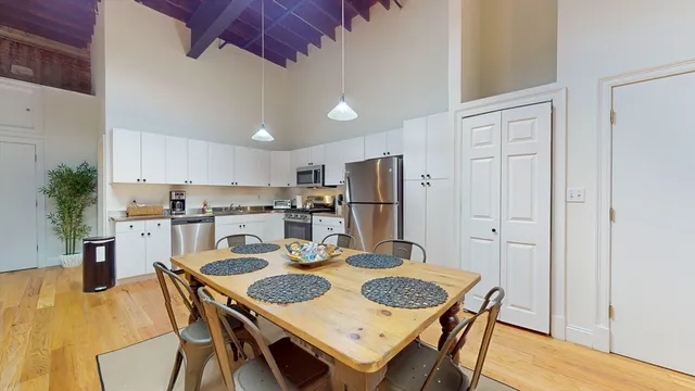 a view of a dining room with furniture and wooden floor