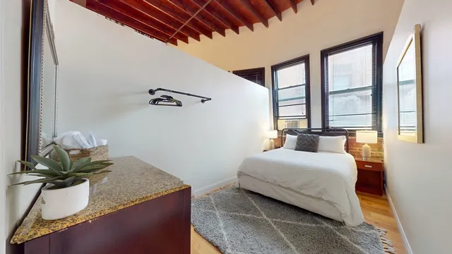 a bedroom with a bed and window