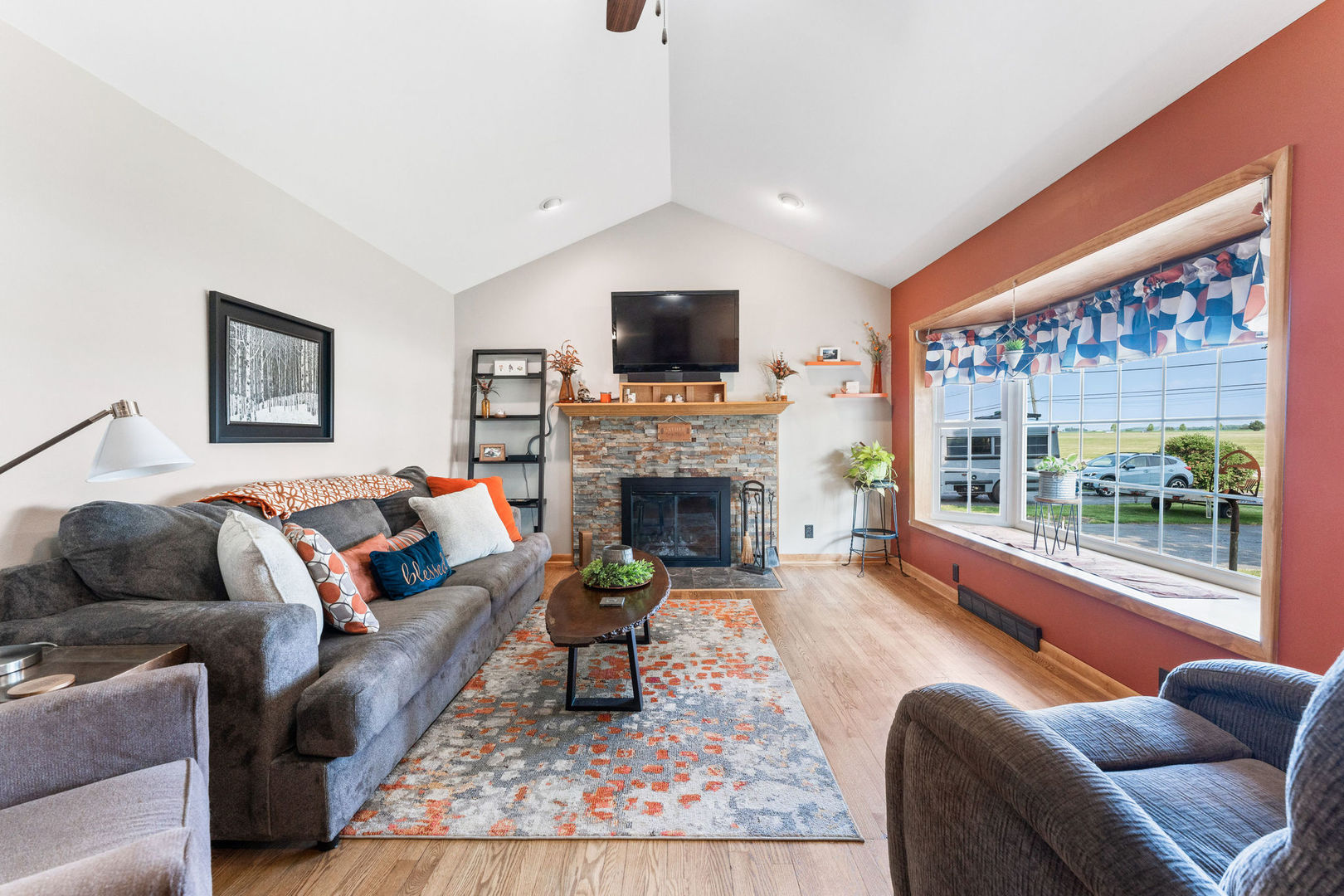 533 Bethany Road Sycamore, IL 60178 - Photo 3 of 38 a living room with furniture a flat screen tv and a fireplace