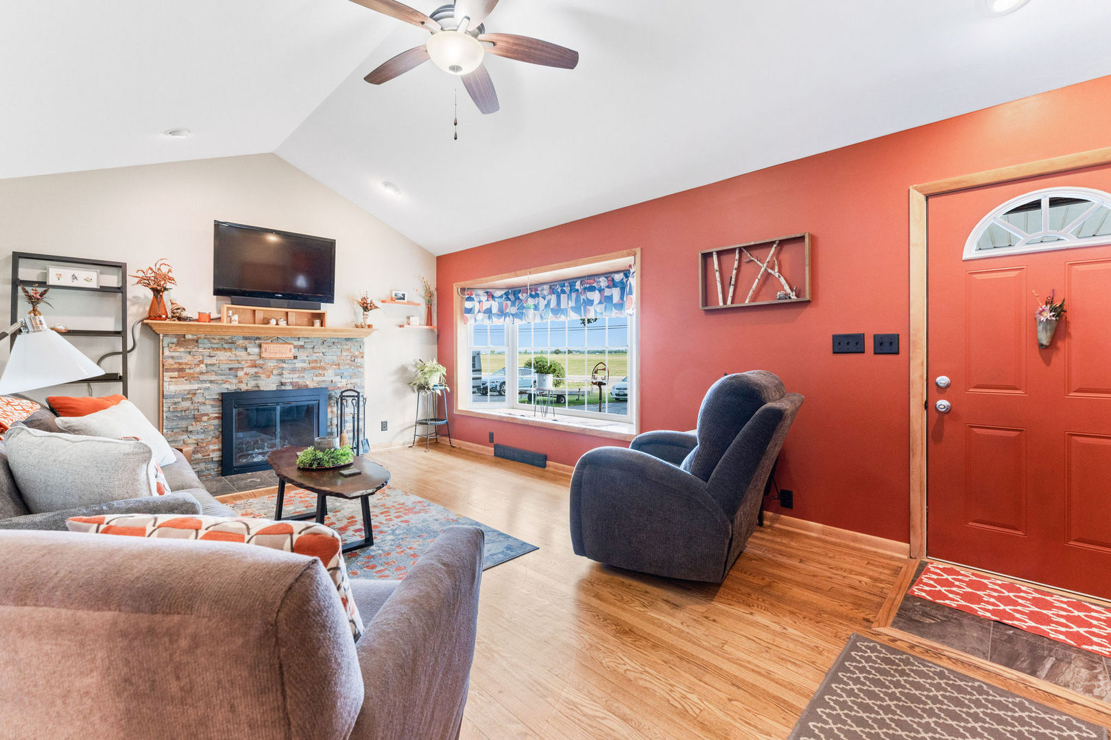 533 Bethany Road Sycamore, IL 60178 - Photo 4 of 38 a living room with furniture a flat screen tv and a fireplace