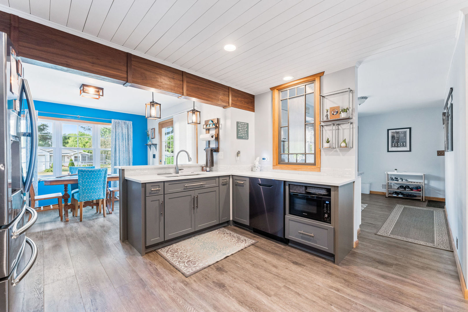 533 Bethany Road Sycamore, IL 60178 - Photo 8 of 38 a large kitchen with stainless steel appliances wooden floor and a view of living room