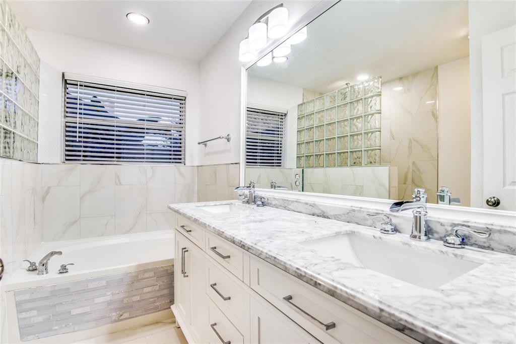 2504 Whetstone Drive Corinth, TX 76210 - Photo 12 of 19 a bathroom with a granite countertop sink and a bathtub