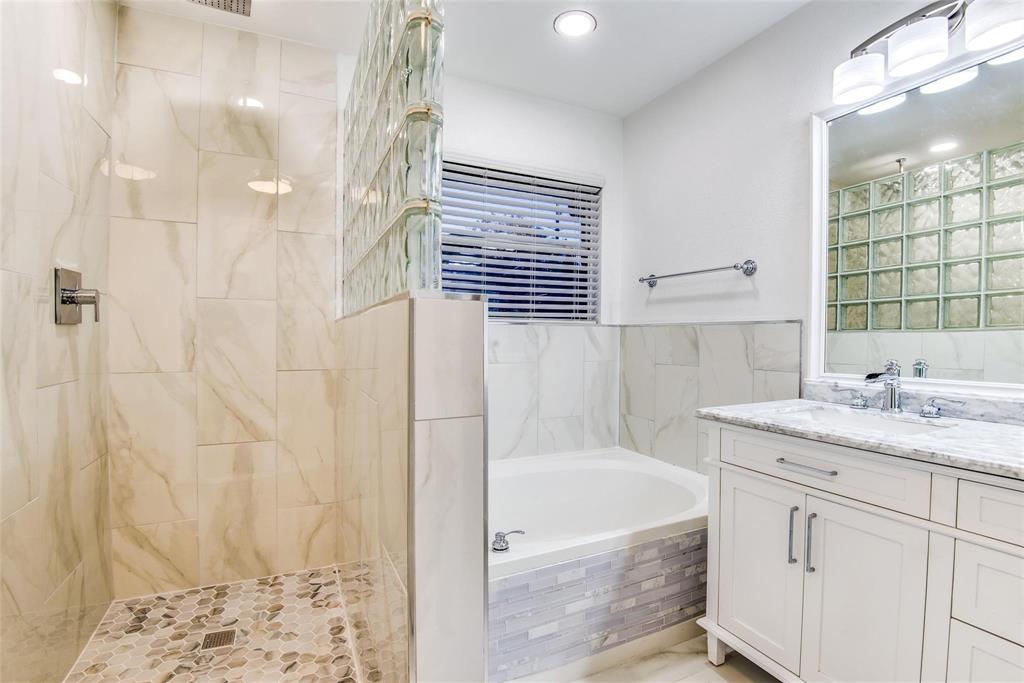2504 Whetstone Drive Corinth, TX 76210 - Photo 13 of 19 a bathroom with a granite countertop sink a bathtub and shower