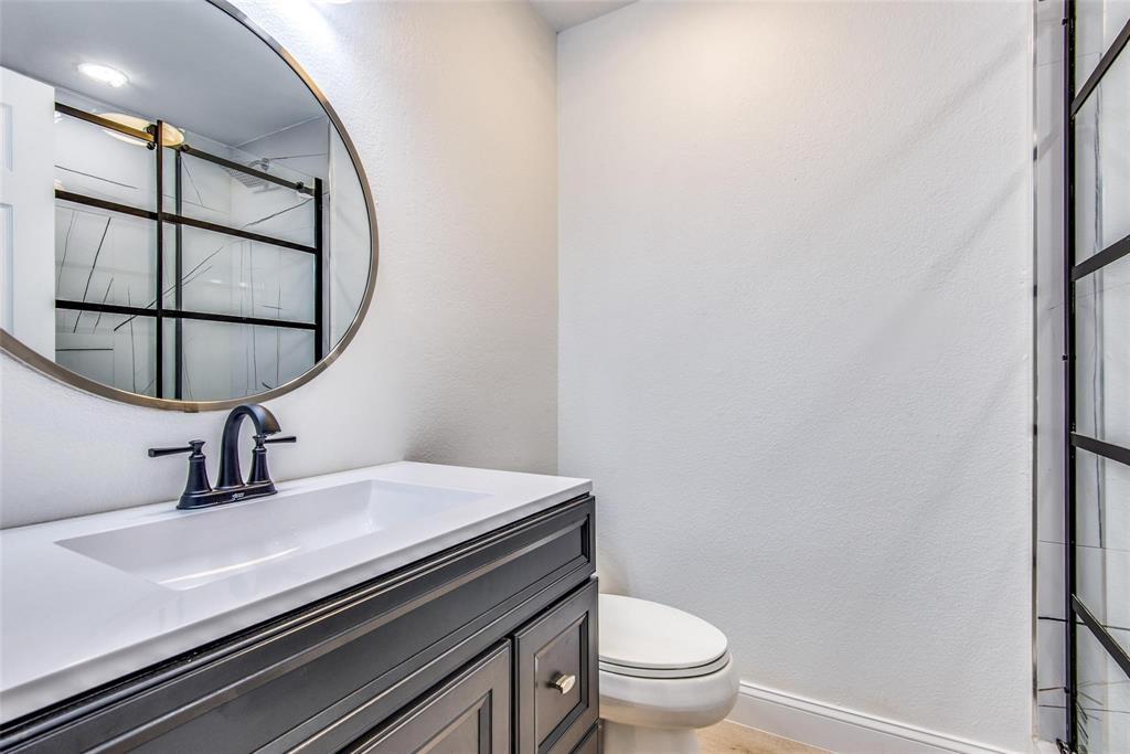 2504 Whetstone Drive Corinth, TX 76210 - Photo 15 of 19 a bathroom with a sink toilet and mirror