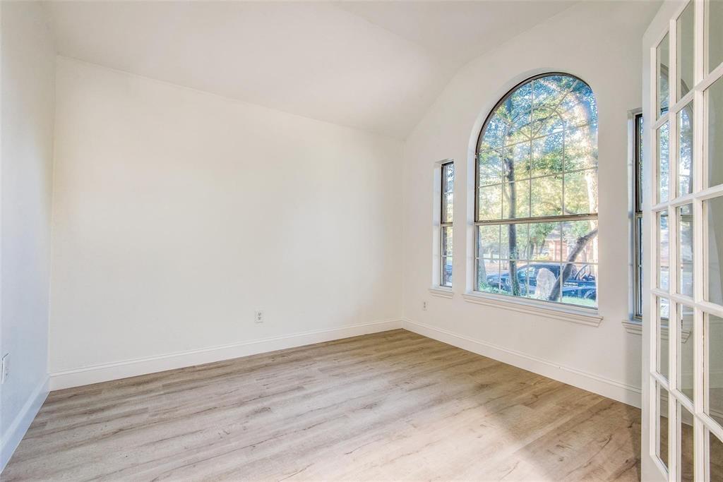 2504 Whetstone Drive Corinth, TX 76210 - Photo 4 of 19 an empty room with wooden floor windows and outdoor view