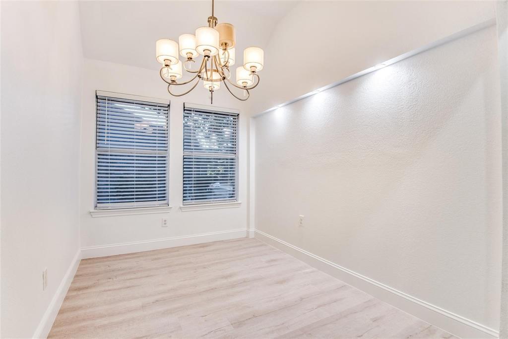2504 Whetstone Drive Corinth, TX 76210 - Photo 5 of 19 a view of an empty room with wooden floor and windows