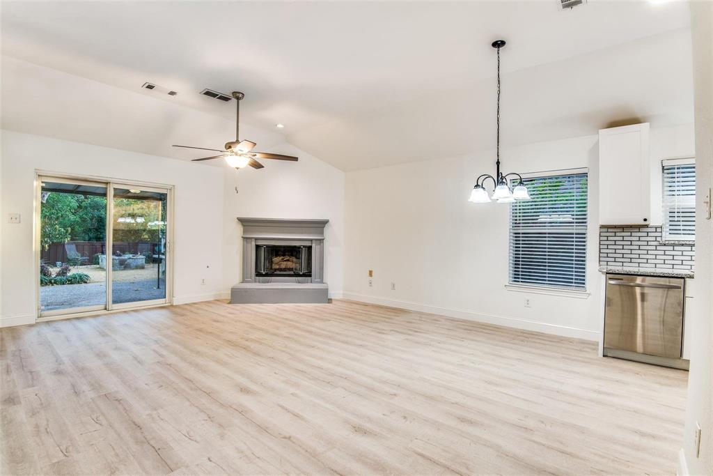 2504 Whetstone Drive Corinth, TX 76210 - Photo 7 of 19 a view of an empty room with a fireplace and a window
