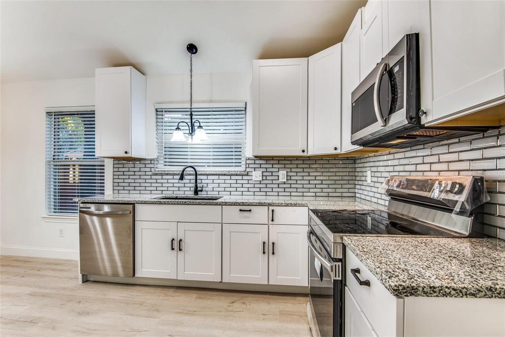 2504 Whetstone Drive Corinth, TX 76210 - Photo 9 of 19 a kitchen with stainless steel appliances granite countertop a sink stove and cabinets