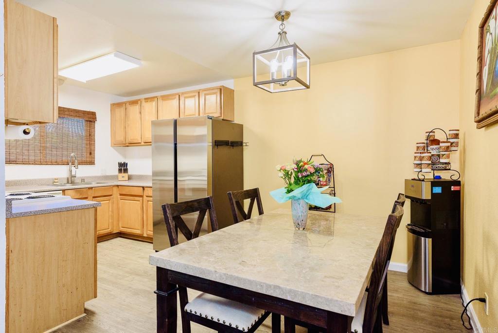 391 Emerald Avenue, Unit 12 El Cajon, CA 92020 - Photo 7 of 15 a kitchen with a table and chairs in it