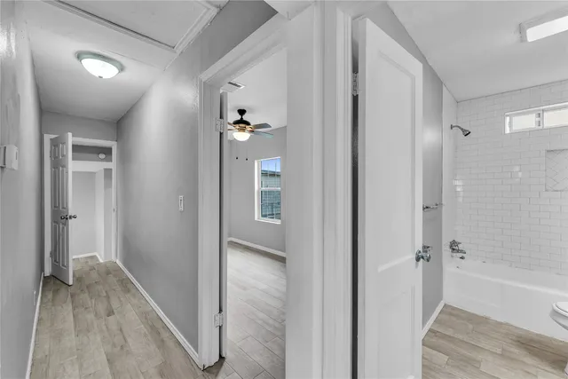 a view of a bathroom with a tub shower and a sink