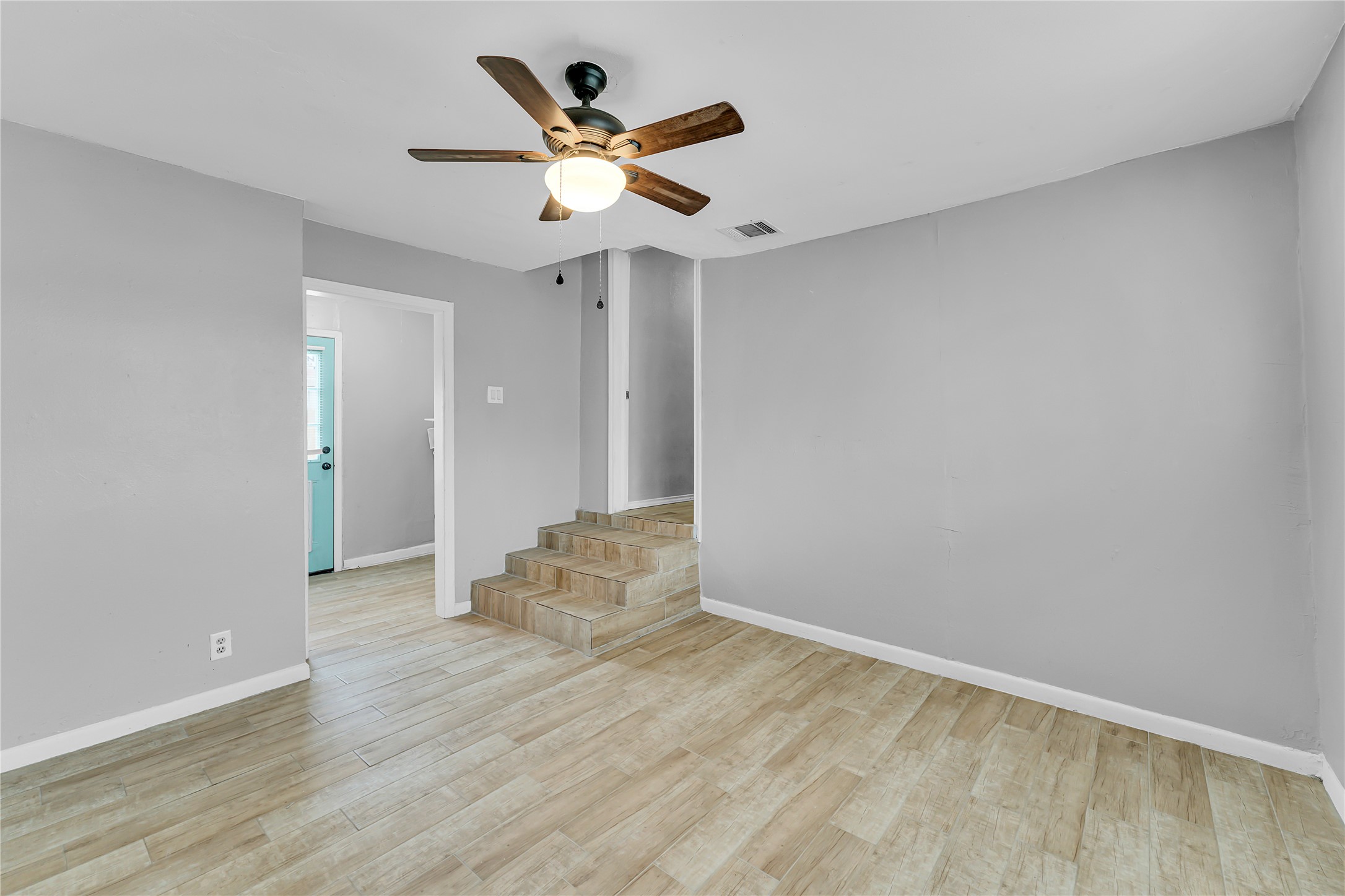 117 Travis Street Taylor, TX 76574 - Photo 15 of 23 wooden floor in an empty room