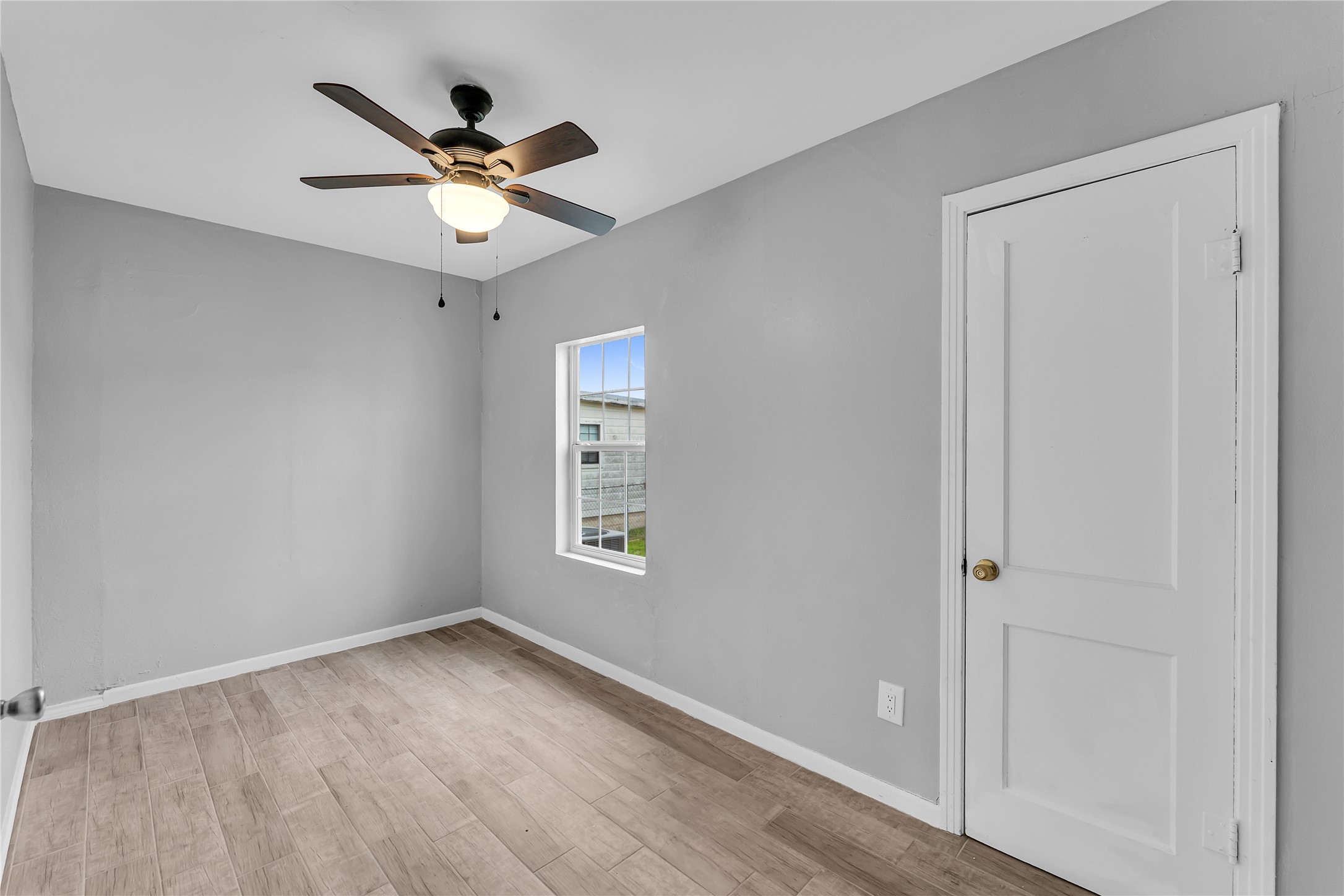 117 Travis Street Taylor, TX 76574 - Photo 16 of 23 wooden floor in an empty room with a window