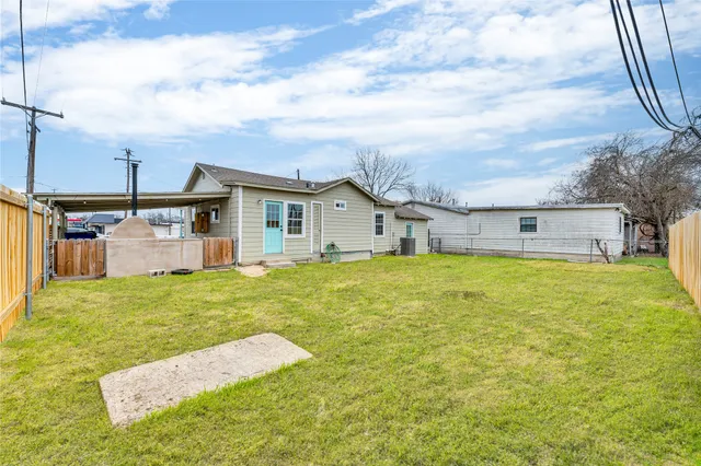 a swimming pool with some plants and large trees