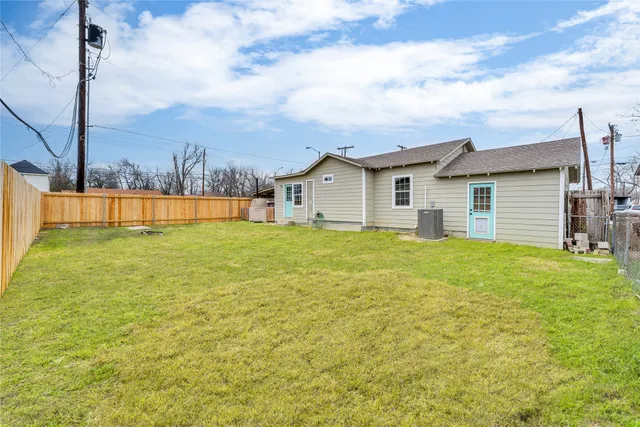 a view of a house with a big yard and potted plants