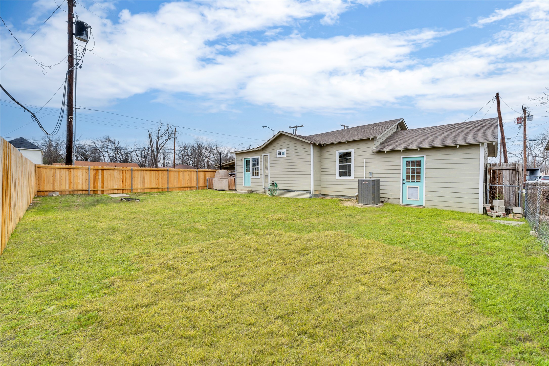117 Travis Street Taylor, TX 76574 - Photo 3 of 23 a view of a house with a big yard and potted plants